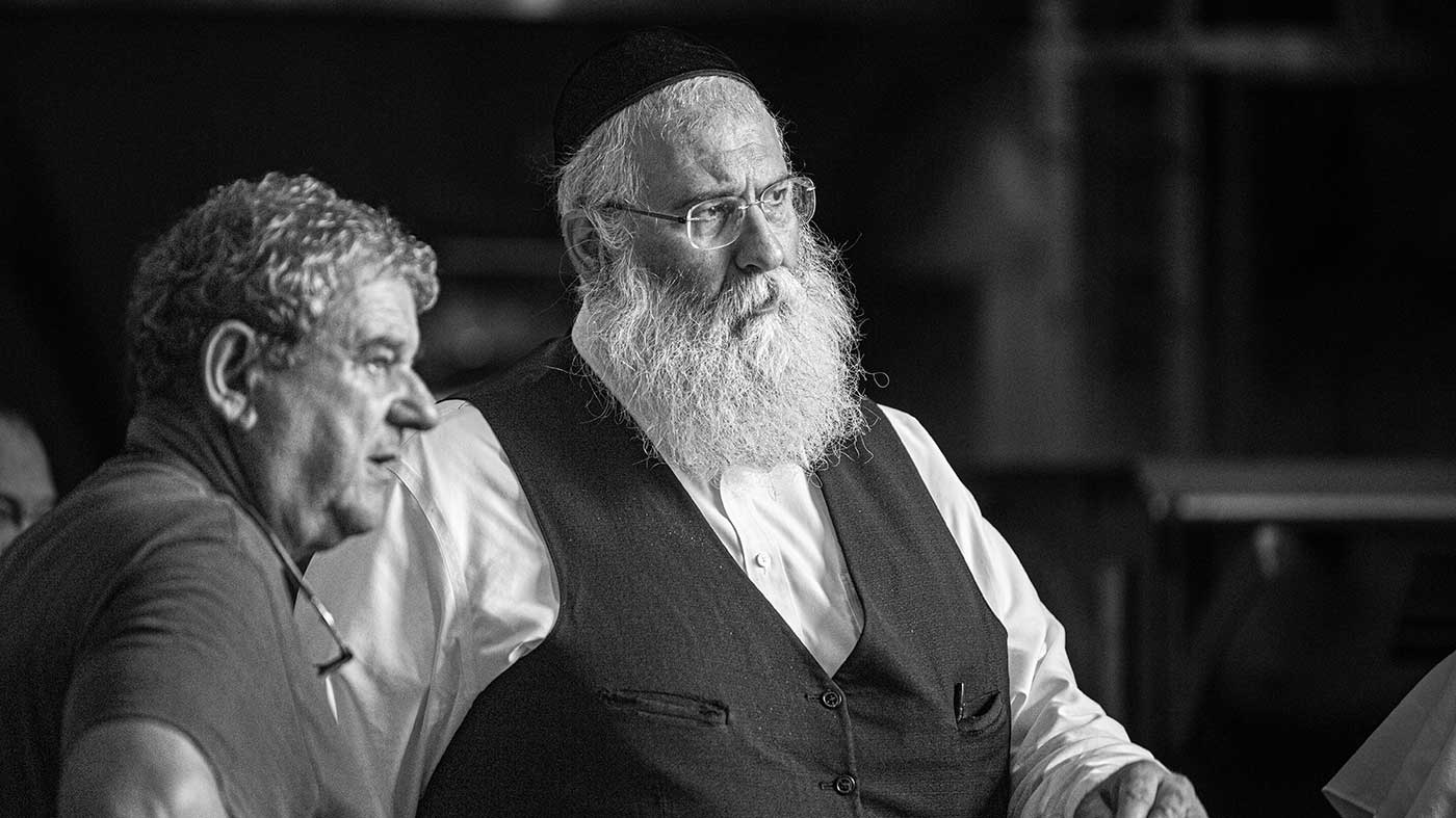 HaRav Michoel Scharf, head of certifying agency Kedassia of London, discussing the production details of a kosher vintage with a winemaker.